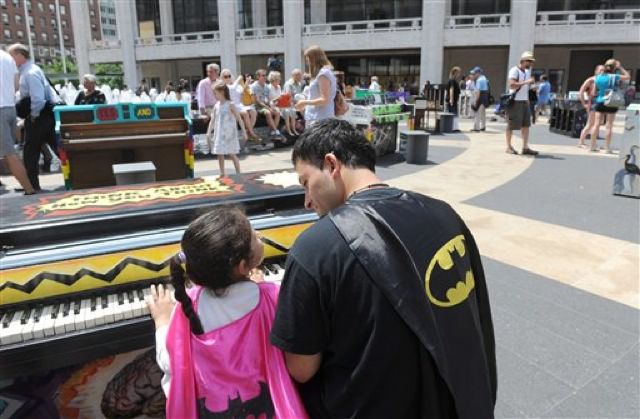 A father and daughter play the piano—and probably fight crime too